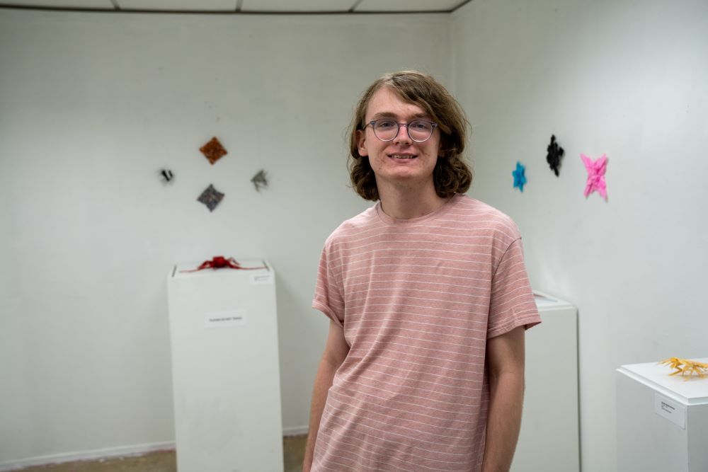 Collin Crowder with work on display in Biggin Hall