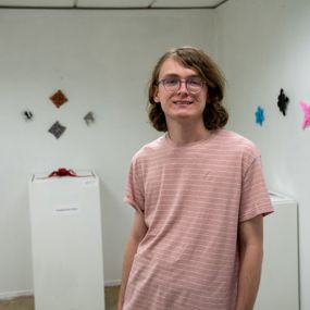 Collin Crowder with work on display in Biggin Hall