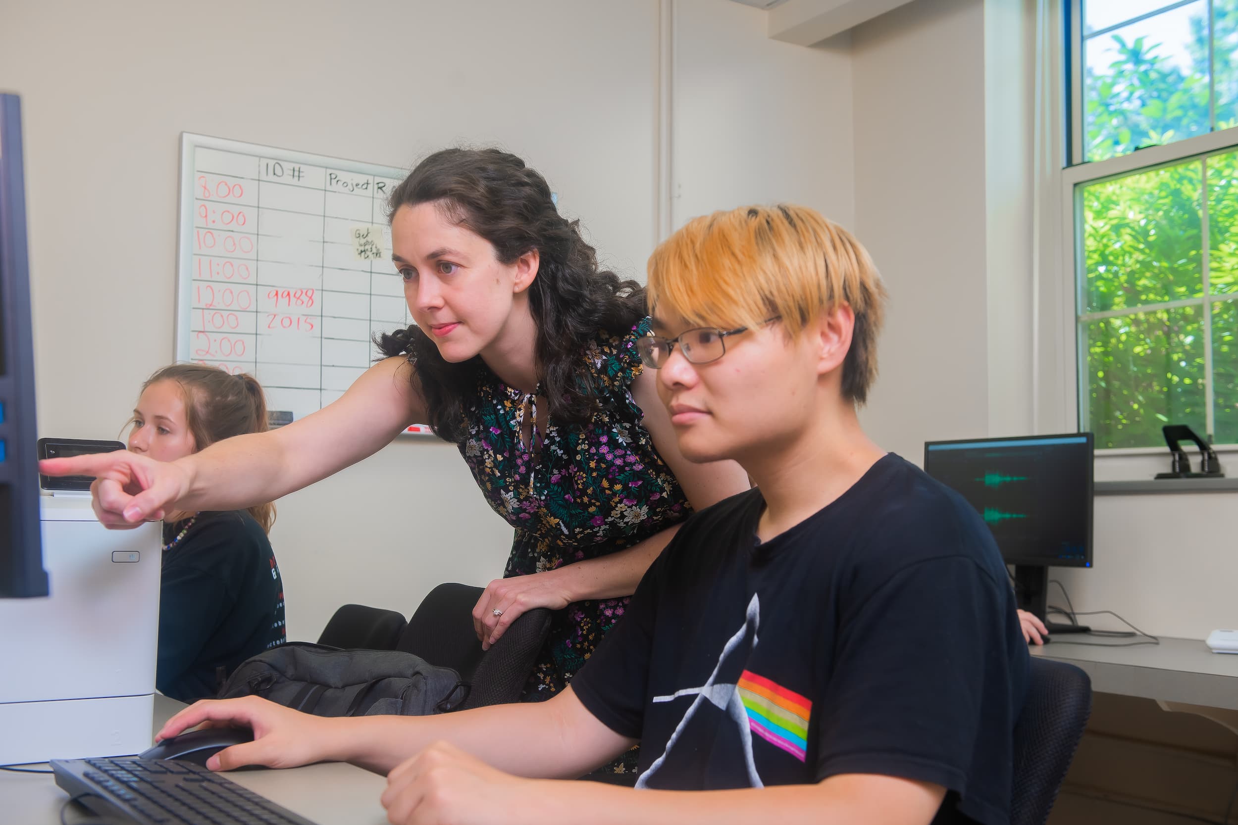 Professor working with students in a psychology lab