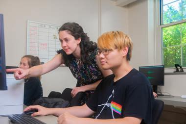 Professor working with students in a psychology lab