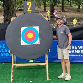 Ben Rushton stands next to target at the World Games in Birmingham