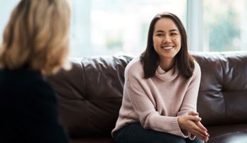 A woman smiling during a therapy session