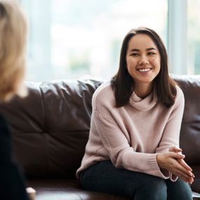 A woman smiling during a therapy session