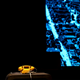Yellow telephone sitting on stage in front of a blue background during Jitney