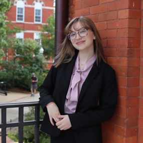 Maggie Haggerty in business attire posing for a photo on Auburn's campus