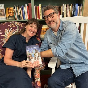Tina Mozelle Braziel and Jim Braziel holding a copy of their book Glass Cabin