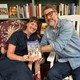 Tina Mozelle Braziel and Jim Braziel holding a copy of their book Glass Cabin