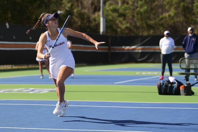 Taylor Russo playing tennis on the Auburn University team