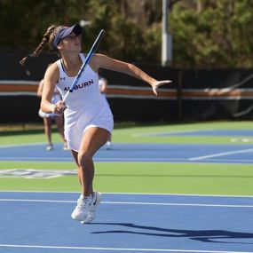 Taylor Russo playing tennis on the Auburn University team