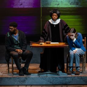 Judge presiding over two citizens, a man looking away and a woman crying, in the show Wellesley Girl