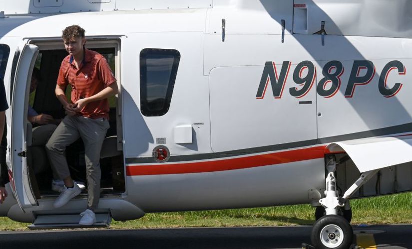 a man exiting a helicopter