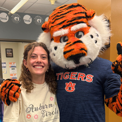 julianna acomb poses with aubie mascot