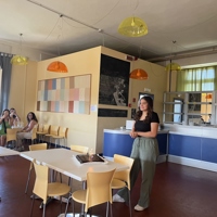 Student Talking To Group In A Dining Room