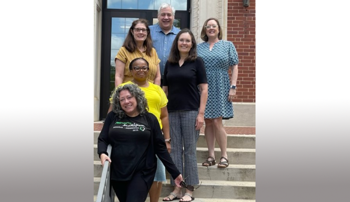 Writing retreat participants pose for a photo on the Tichenor Hall steps