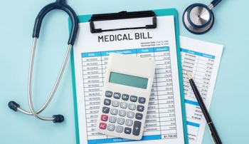 A stethoscope and calculator sitting atop a stack of medical bills