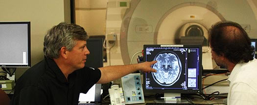 two professors looking at MRI scan