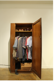 photo of open dresser with clothes in it